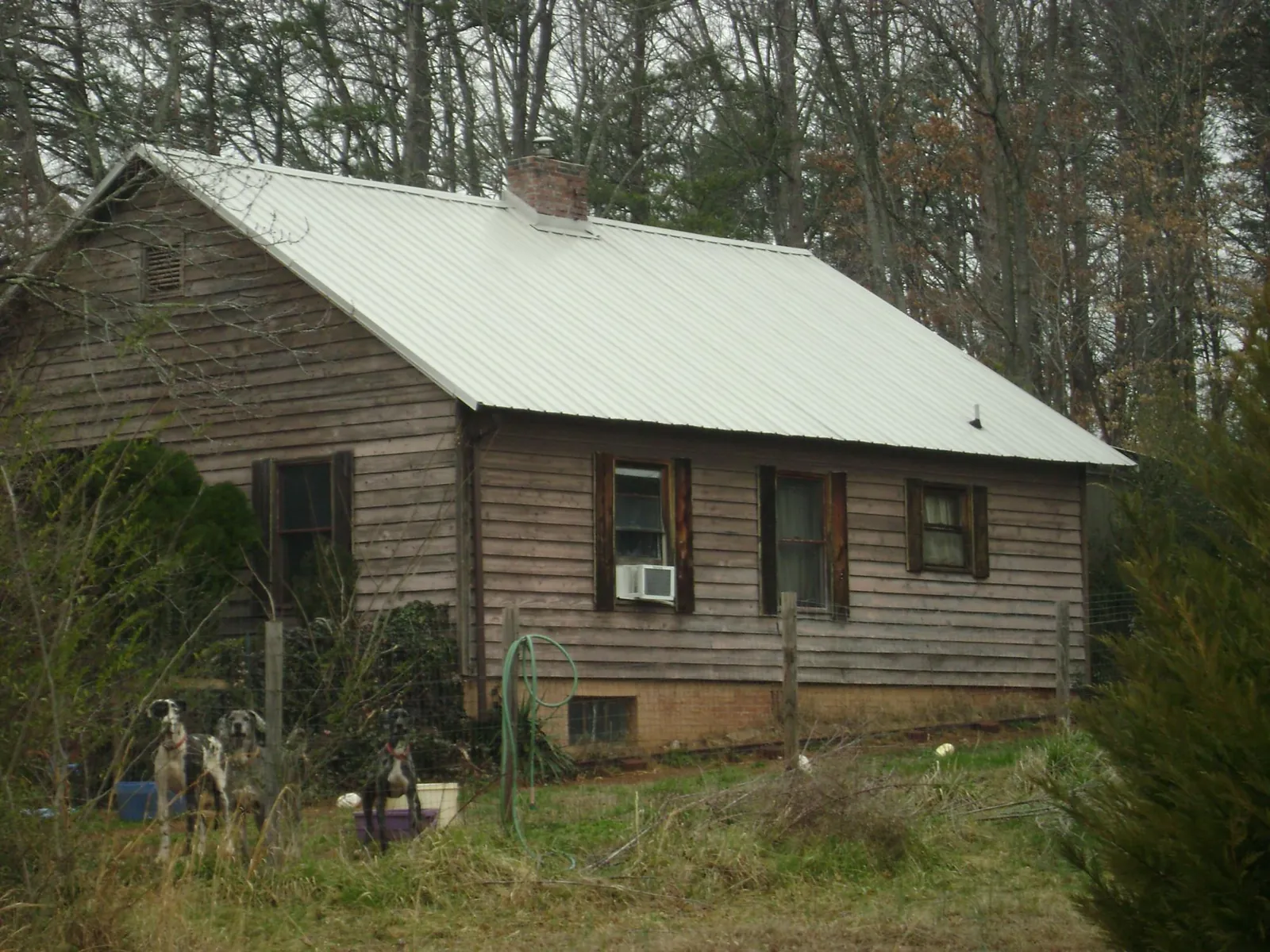 White metal roof on an old wood sided farmhouse in Clinton